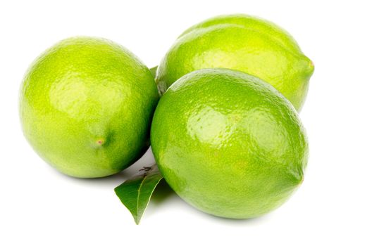 Arrangement of Three Fresh Ripe Limes with Leaf isolated on white background