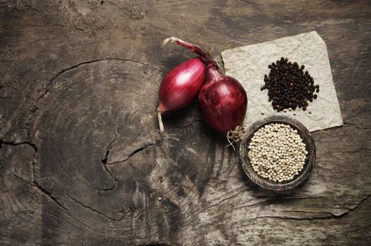 Onions and spices on a old wooden table