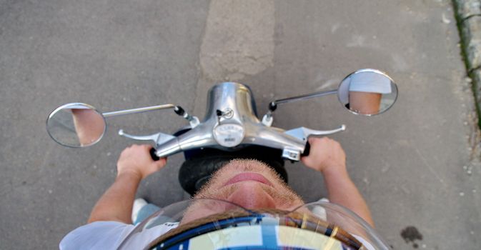 Hairy guy on a scooter