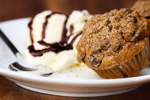 Delicious homemade pumpkin chocolate chip muffins with french vanilla ice cream. Extreme shallow depth of field. 