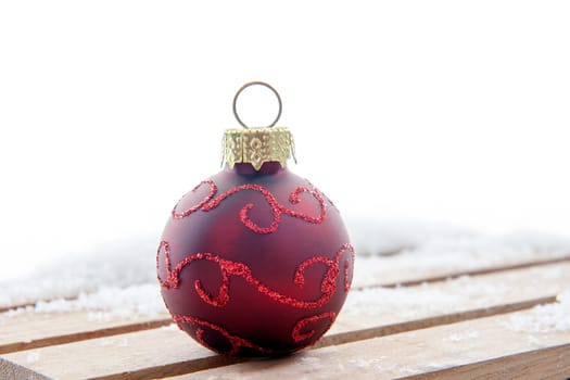 A red christmas ball in the snow