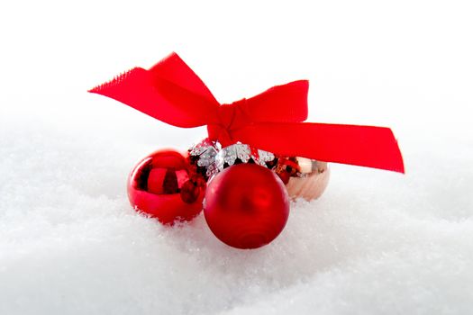 Red christmas balls in the snow