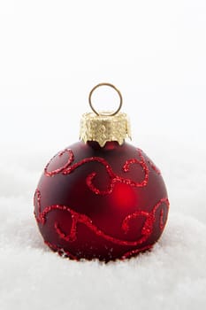 Red christmas ball in the snow