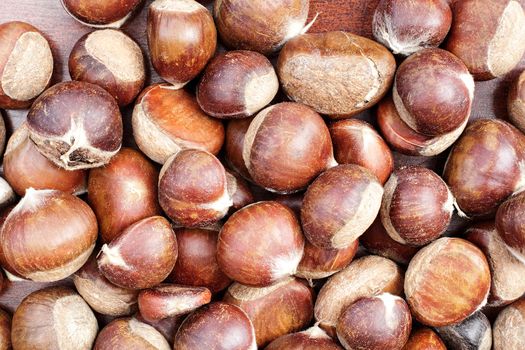 Full frame of fresh chestnuts in the shell.