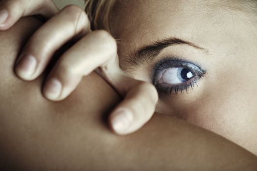 Close-up photo of the woman face covered by the hand