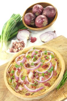 Onion tart with leeks on a light background