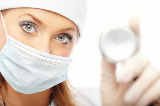 Doctor in protective mask and rubber gloves holding stethoscope