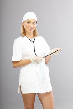 Smiling nurse in uniform with sexy figure and legs