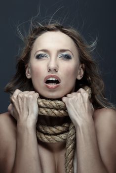 Suffering woman in crisis with terrible rope on her neck