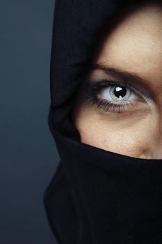 Woman with covered face looking to the camera