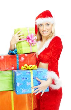 Smiling happy lady in the red Santa Claus costume holding gift boxes on a white background