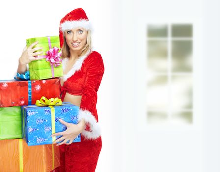 Smiling lady in Santa Claus costume with Christmas gift boxes