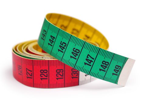 Closeup photo of a yellow, red, and green tape measure. Shallow depth of field.
