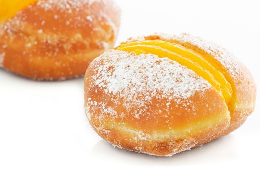 Portuguese doughnuts or Berliners with egg creme over white background