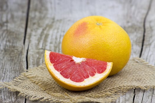 red grapefruit on old wooden background