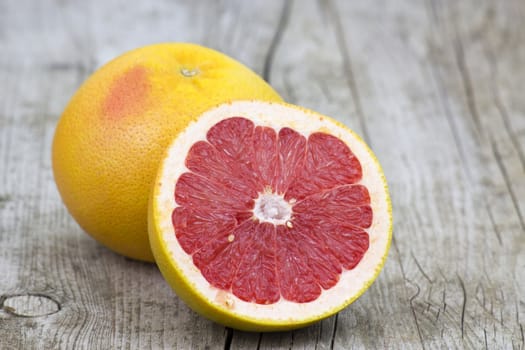 red grapefruit on old wooden background