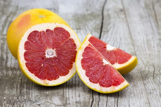 red grapefruit on old wooden background