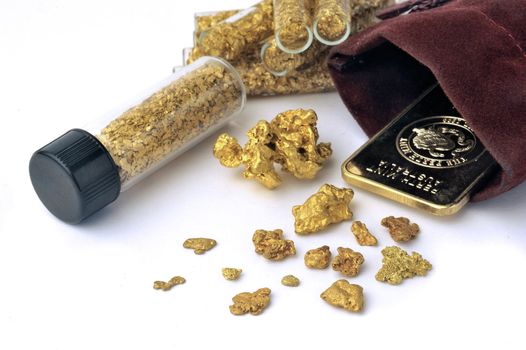 nuggets and gold bullion in studio on white background