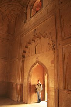 Young woman standing inside Safdarjung Tomb, New Delhi, India