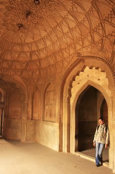 Young woman standing inside Safdarjung Tomb, New Delhi, India