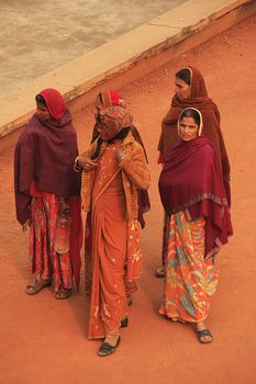 Indian women in colorful sari standing in courtyard of Safdarjung Tomb, New Delhi, India