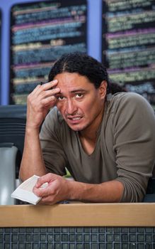 Stressed out Native American restaurant owner at counter