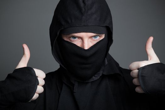 Attractive 30 years old caucasion man shot in studio isolated on a grey background