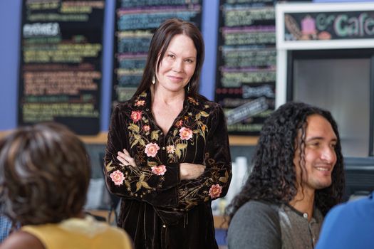 Beautiful mature woman standing in coffee house