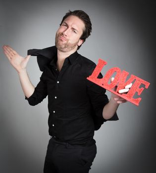 Attractive 30 years old caucasion man shot in studio isolated on a grey background