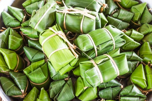 Khao tom mad is a Thai traditional dessert made from sticky rice, coconut milk, sugar , and bananas wrap with banana leaf.