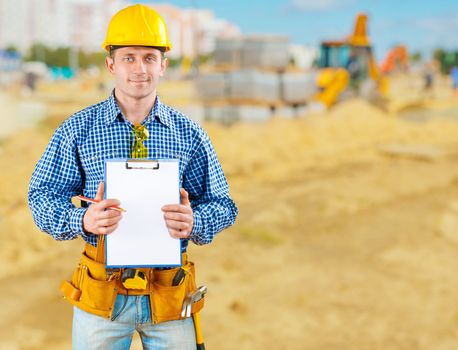 contractor on road construction with clipboard