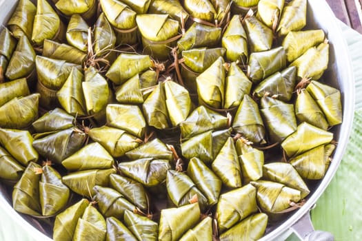 Khao tom mad is a Thai traditional dessert made from sticky rice, coconut milk, sugar , and bananas wrap with banana leaf.