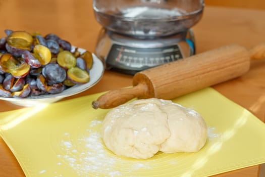 dough for plum cake with kitchen scale in background