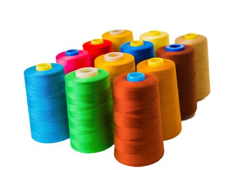 Colored fine thread bobbins on white