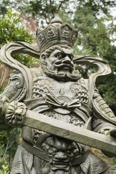 Aged asian god stone statue.