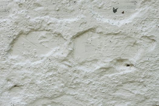 Fragment of old concrete wall whitewashed with lime