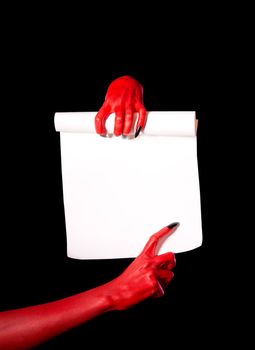 Red devil hands holding paper scroll and pointing at signature place  