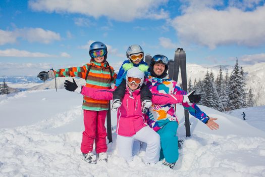 Skiing, winter, snow, sun and fun - family enjoying winter vacations