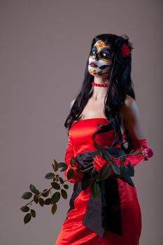 Sugar skull girl in red evening dress, Halloween shot  