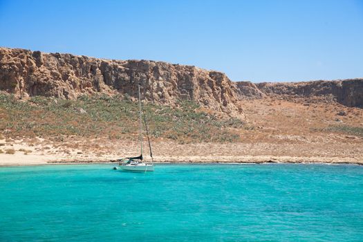 Yacht boat in beautiful tropical lagoon with turquoise water, Gramvousa island, Greece 