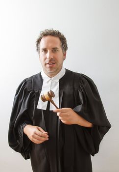 Man in canadian laywer robe with a gavel in his hand