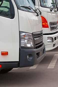 New trucks in  row in  parking lot closeup.