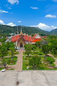 Beautiful park of  Buddhist temple on  background of blue sky, Thailand.
