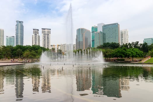 Fountain in modern city skyline with skyscraper on background