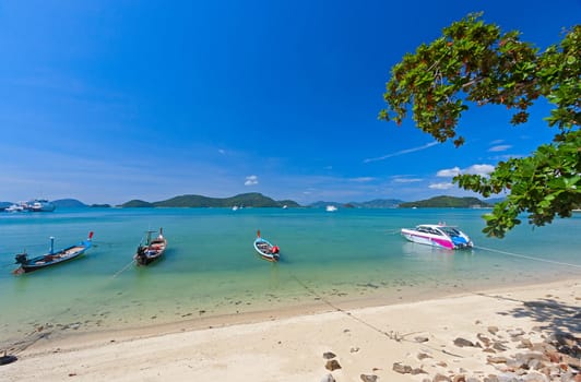 Boats near  shore waiting for tourists, Thailand. Beautiful tropical landscape.