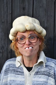 Bizarre woman with a pumpkin on her head.