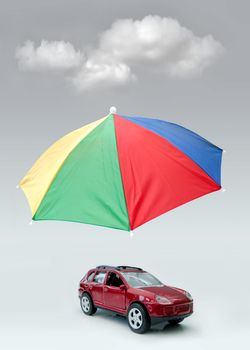 Umbrella shielding a car from hovering clouds 