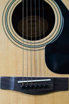 Acoustic brown guitar.Zoom in the acoustic guitar strings.