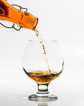 Pouring a glass of brandy from a bottle