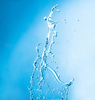 shot of water splashing on blue background